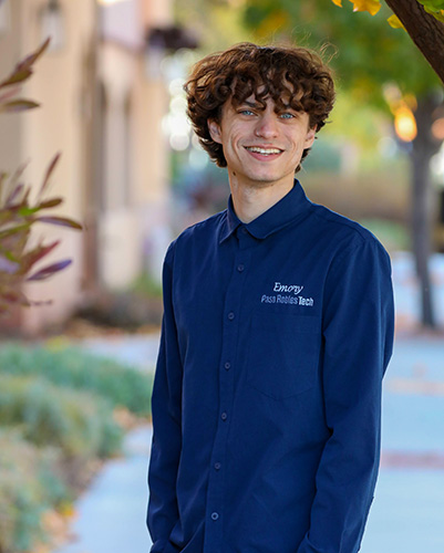 Emory Kirker, Cybersecurity Specialist at Paso Robles Tech, photographed outdoors in a Paso Robles Tech shirt
